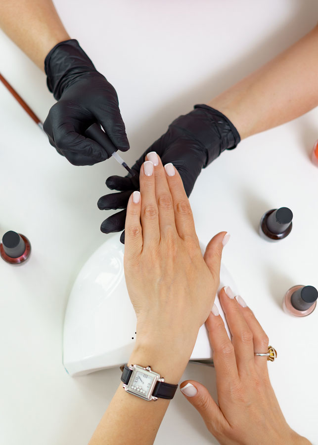 Manicurist treating a client at Shear Salon